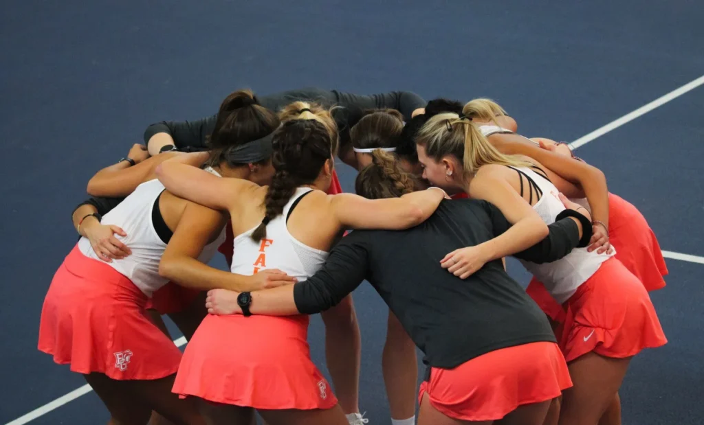 Tennis team hugging