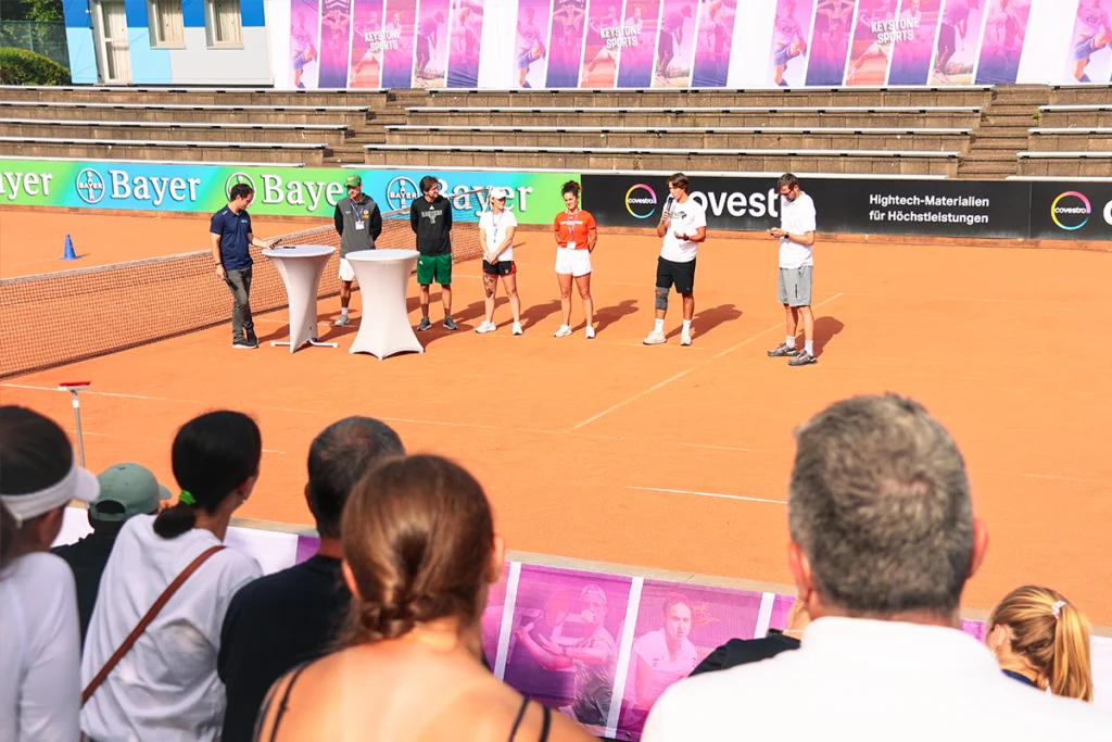 Q&A with college coaches on a tennis court