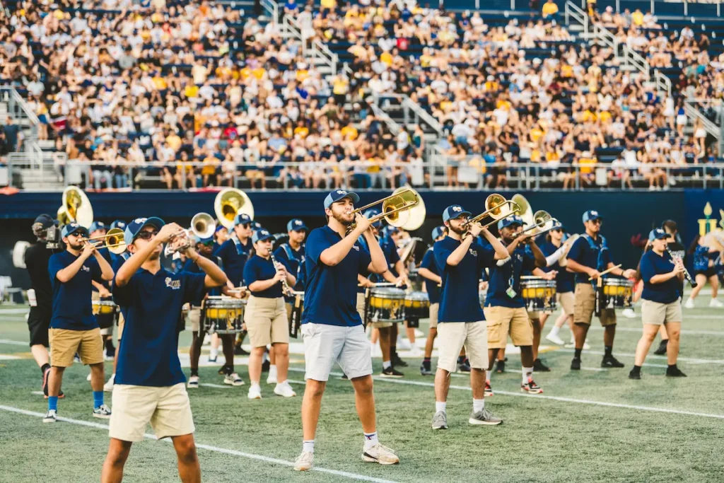 Student marching band performing during a college football halftime show.