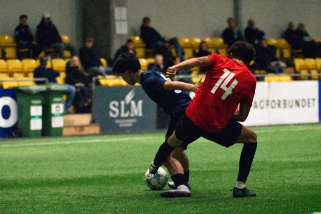 Two players fighting for a ball as college coaches look on at the Keystone Sports College Soccer Showcase
