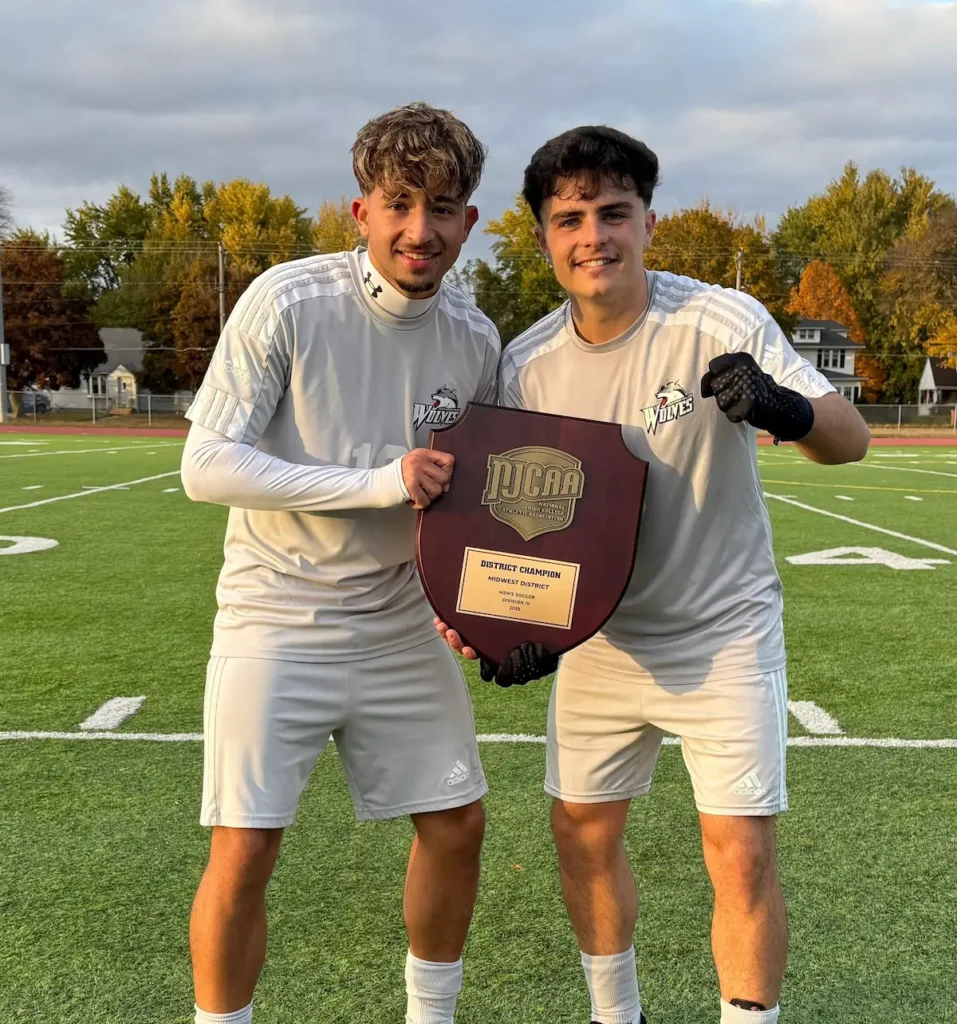 Francisco Sanches do Nascimento and his teammate posing with their title